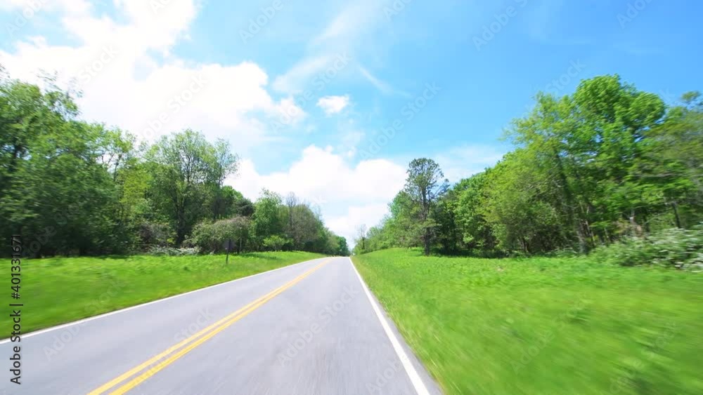 Point of view pov handheld front view of car driving on Shenandoah Skyline Drive by park mountain forest in summer with green foliage trees Point of view pov handheld front view of car driving on Shenandoah Skyline Drive by park mountain forest in summer with green foliage trees