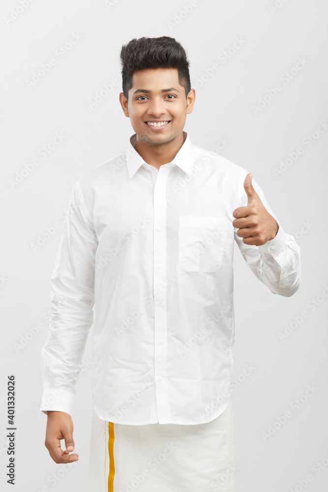 Cheerful handsome south Indian man showing thumbs up on white. Cheerful handsome south Indian man showing thumbs up on white.