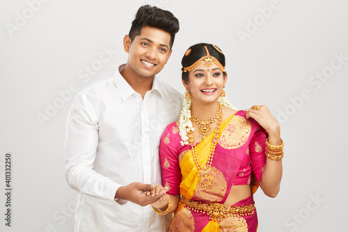 Photography Attractive happy south Indian couple in traditional dress on white