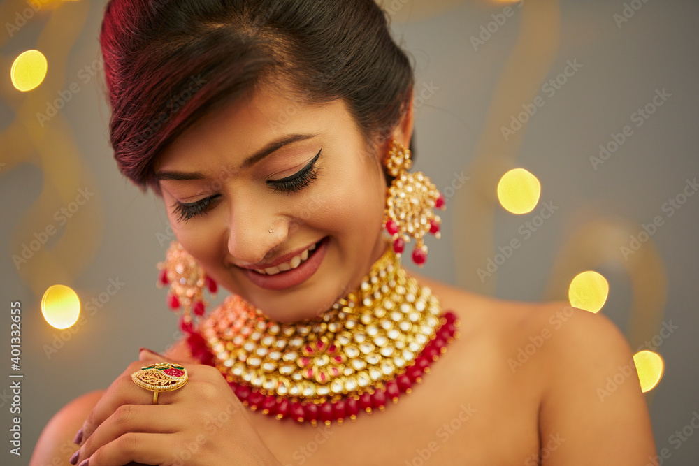 Beautiful Indian young women portrait with Indian traditional jewelry studio shot. - obrazy, fototapety, plakaty 