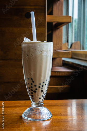 The close up of Taiwan original traditional bubble milk tea beverage, Taiwanese cold drink on classic wooden table.