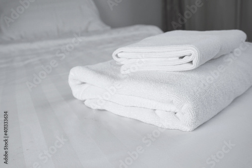 Pile of White Towels on the bed.