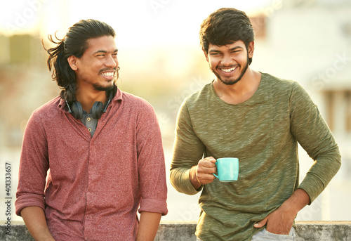 Photography Cheerful young friends chatting on terrace.