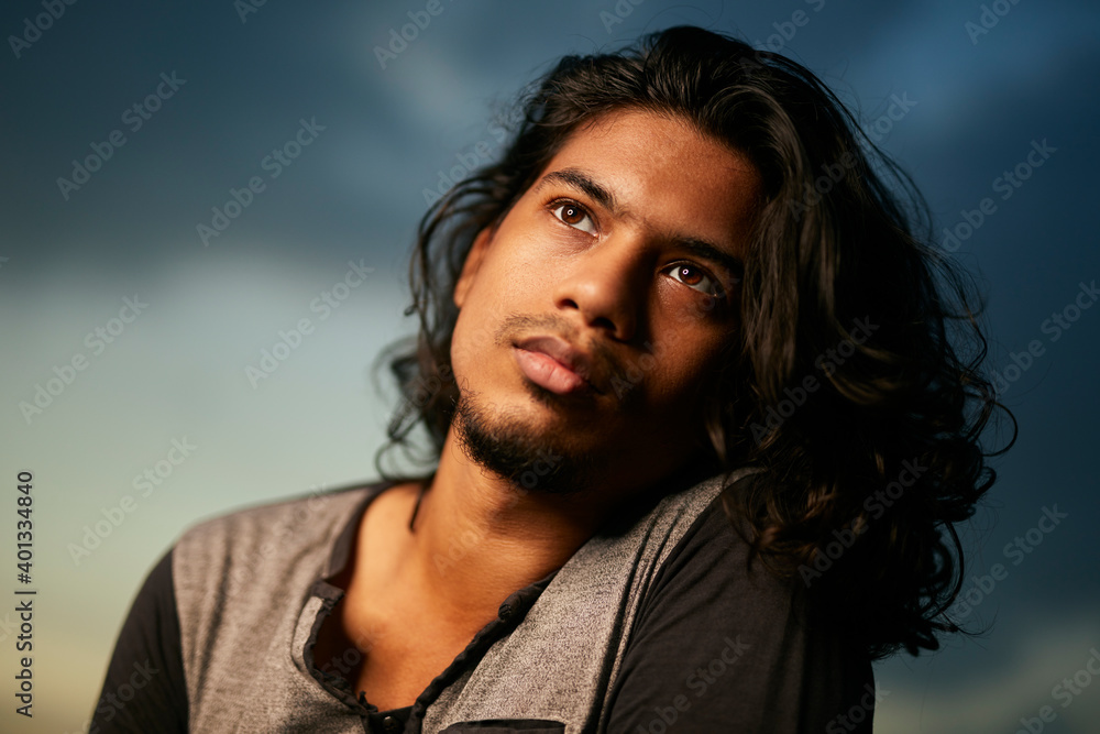 Young man portrait with long hair in evening light Young man portrait with long hair in evening light