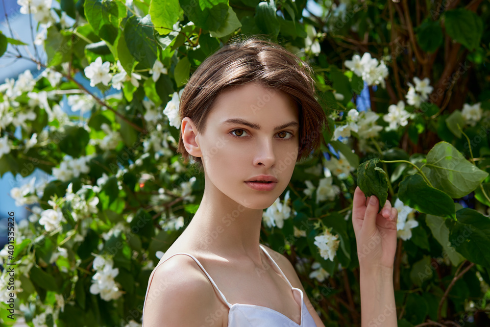 Attractive modest young woman natural makeup in a white dress outdoors Attractive modest young woman natural makeup in a white dress outdoors