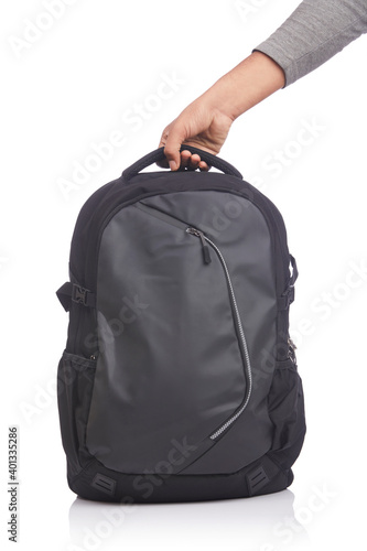 Hand holding black backpack on white background