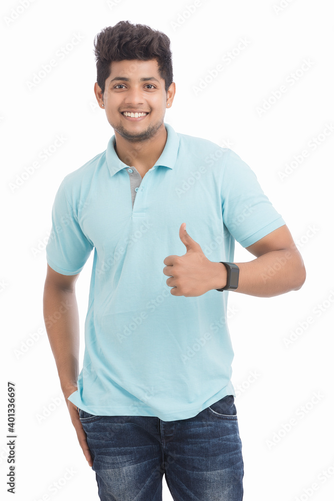 Handsome Indian young man showing thumbs up isolated on white. Handsome Indian young man showing thumbs up isolated on white.