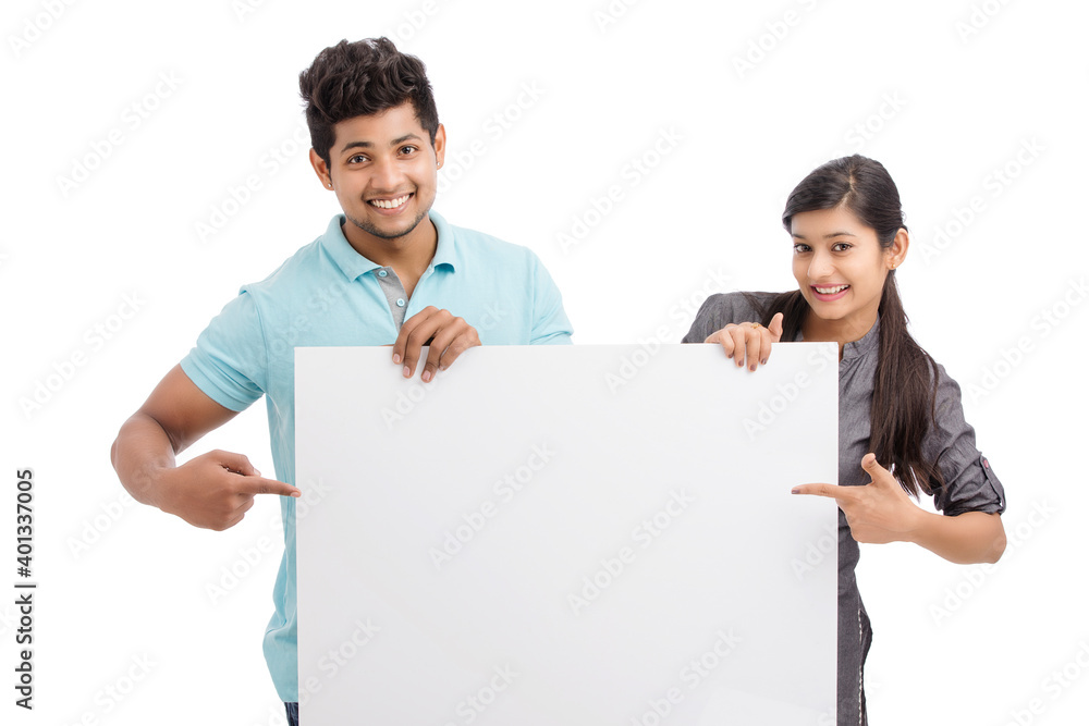 Cheerful cute young couples holding white board isolated on white. Cheerful cute young couples holding white board isolated on white.