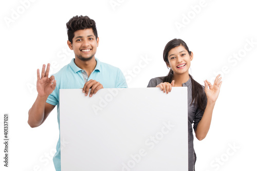 Photography Cheerful cute young couples holding white board isolated on white