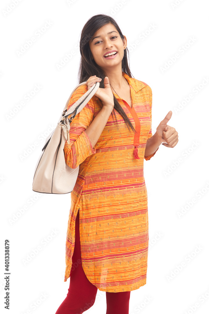 Beautiful young women posing with handbag against white background. Beautiful young women posing with handbag against white background.