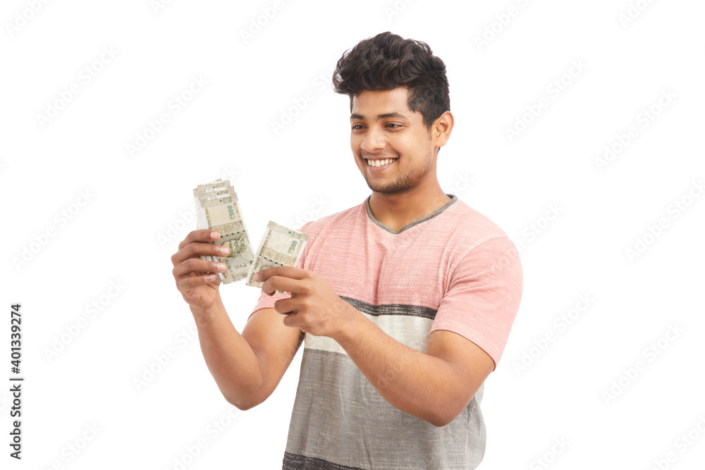 Attractive young Indian cheering with Indian rupees on white. Attractive young Indian cheering with Indian rupees on white.