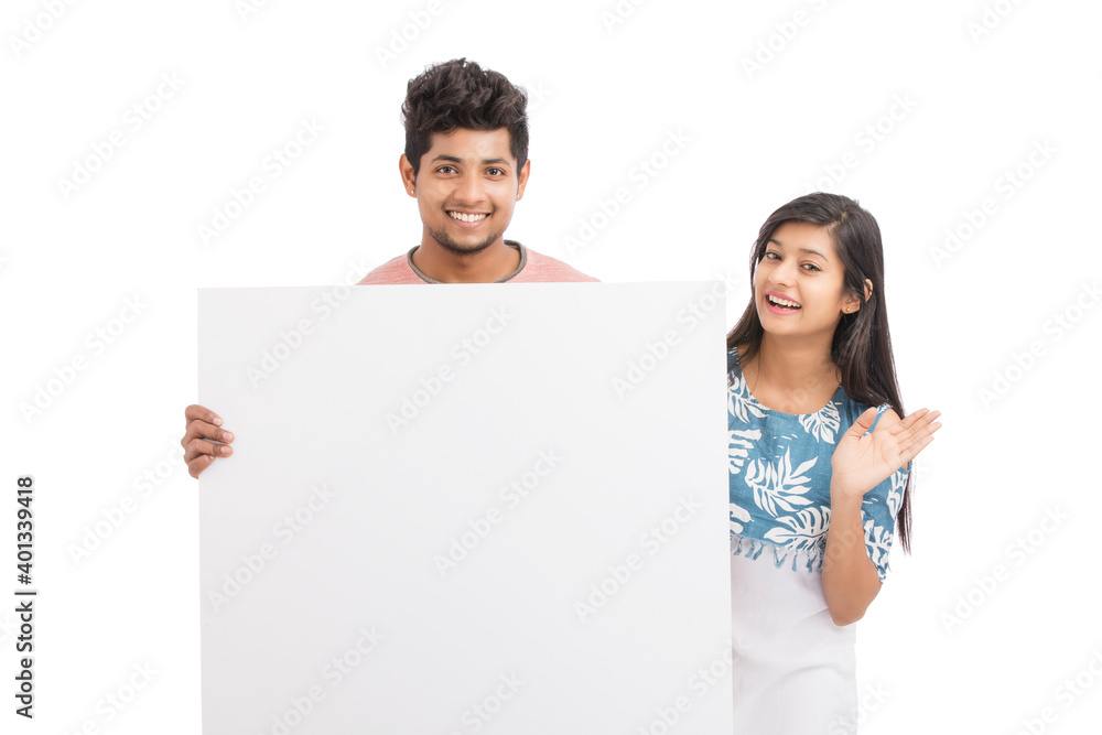 Cheerful young couple holding billboard on white background. Cheerful young couple holding billboard on white background.