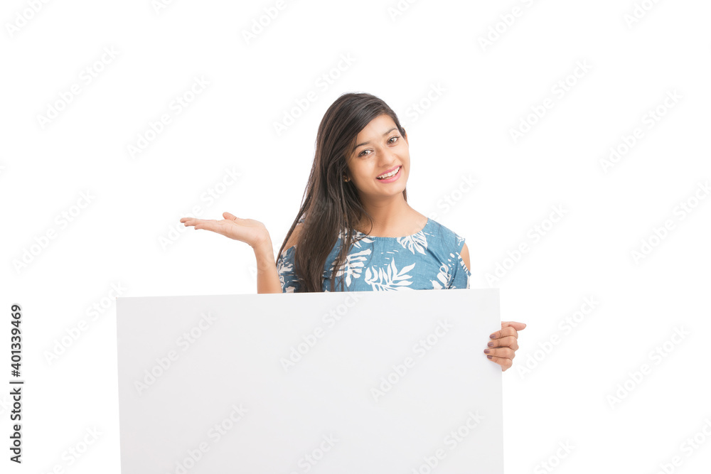 Cheerful attractive young women holding white board on white background. Cheerful attractive young women holding white board on white background.