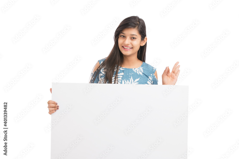 Cheerful attractive young women holding white board on white background. Cheerful attractive young women holding white board on white background.