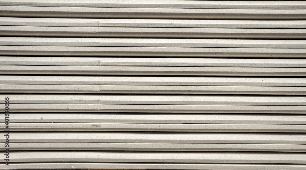 Plasterboard sheets in a bundle as a background at a construction site Plasterboard sheets in a bundle as a background at a construction site