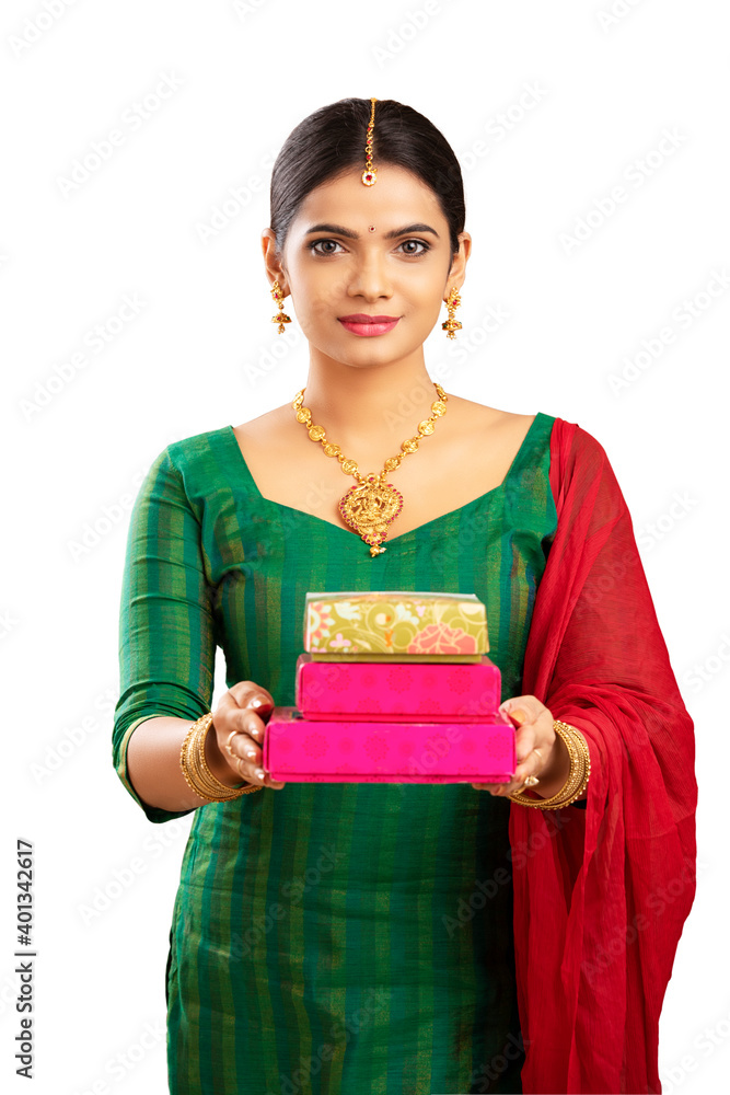 Indian young woman offering sweet box studio shot. Indian young woman offering sweet box studio shot.