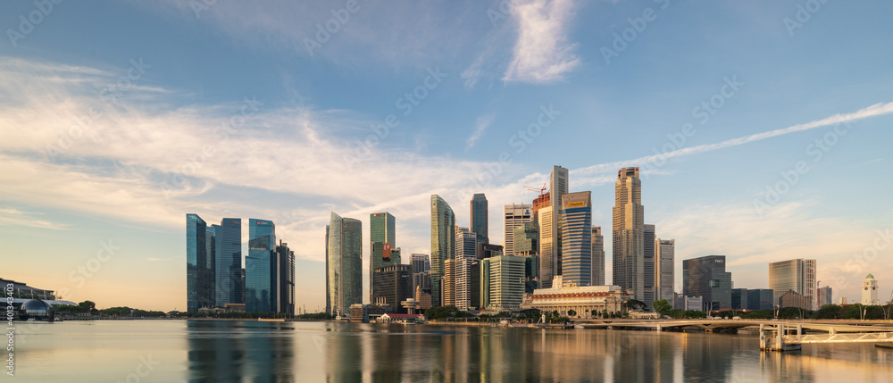Ultra wide panorama image of Singapore skyscrapers illuminated by morning sunlight early in the morning. Ultra wide panorama image of Singapore skyscrapers illuminated by morning sunlight early in the morning.