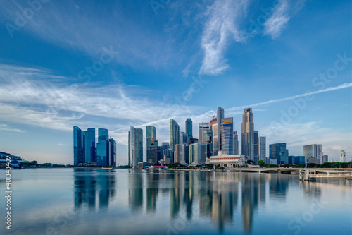 Wide panorama image of Singapore skyscrapers illuminated by morning sunlight early in the morning. © hit1912