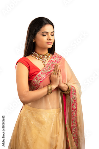Pretty Indian young woman praying studio shot