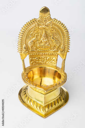 Brass oil lamp (kamachi vilakku) on white. photo