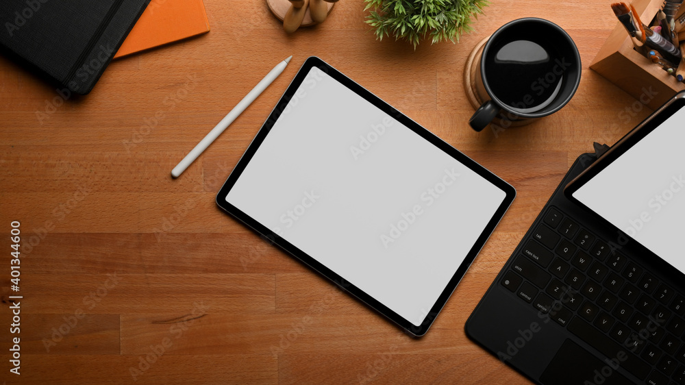 Top view of wooden table with tablet, stationery, coffee cup and copy space Top view of wooden table with tablet, stationery, coffee cup and copy space