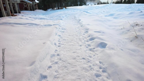 Wallpaper Mural Trails in the snow leading toward small village on a cold winter evening Torontodigital.ca
