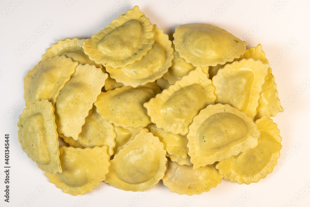 Tasty raw ravioli with flour and spinach on white background, process of making italian ravioli, High quality photo