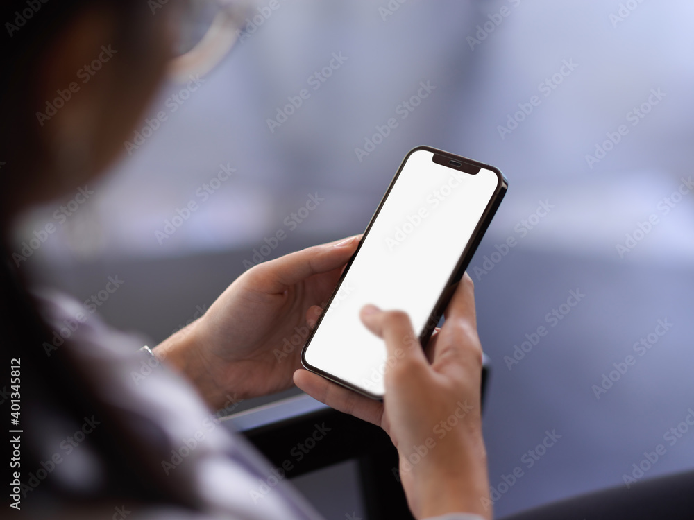 Female office worker relaxing with smartphone in office room Female office worker relaxing with smartphone in office room