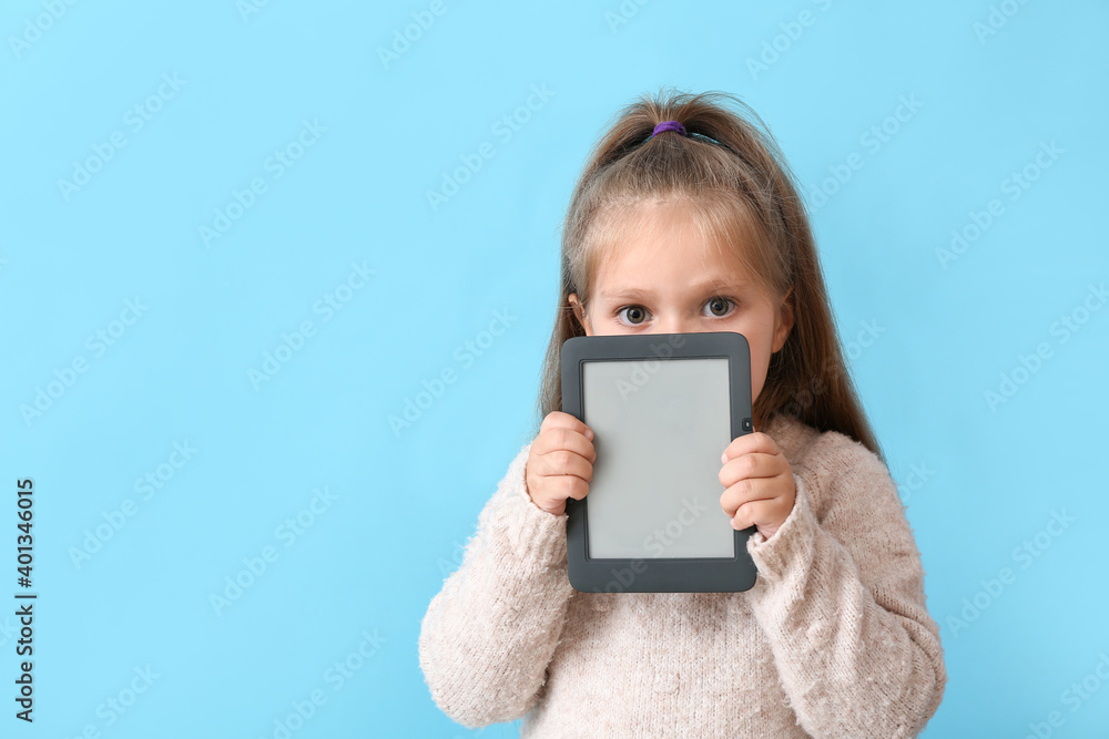 Little girl with e-reader on color background Little girl with e-reader on color background