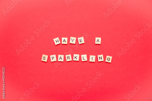 Have a sparkling. The inscription from wooden blocks on a bright red background. New Year. Christmas.