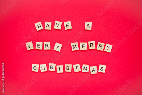 Have a very merry christmas. The inscription from wooden blocks on a bright red background. New Year. Christmas.