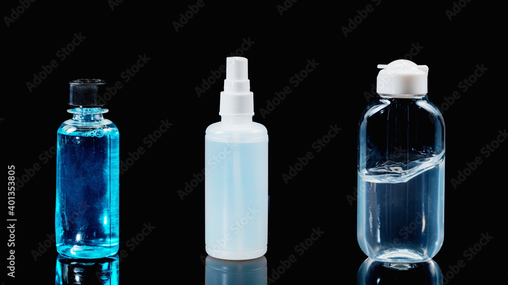 Disinfectants and Sanitizers on black background with reflection. Alcohol Spray, Hand Sanitizer Gel and Mouthwash Liquid. Disinfectants and Sanitizers on black background with reflection. Alcohol Spray, Hand Sanitizer Gel and Mouthwash Liquid.