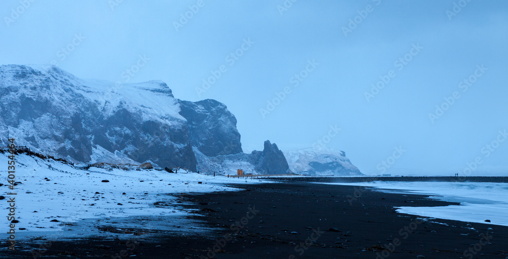 Landscape with the beach of black sand at twilight in winter (near Vik), Iceland.
