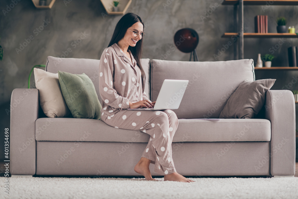 Obraz premium Profile photo of nice optimistic girl sit write laptop wear spectacles pijama at home on sofa