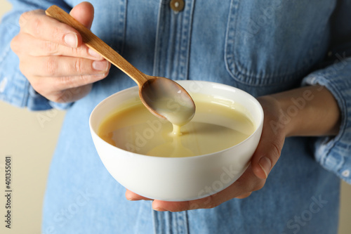 Woman hold bowl with condensed milk, close up