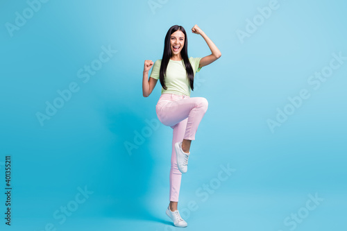 Fototapeta Naklejka Na Ścianę i Meble -  Full length body size view of lovely skinny cheerful girl jumping having fun rejoicing isolated over bright blue color background
