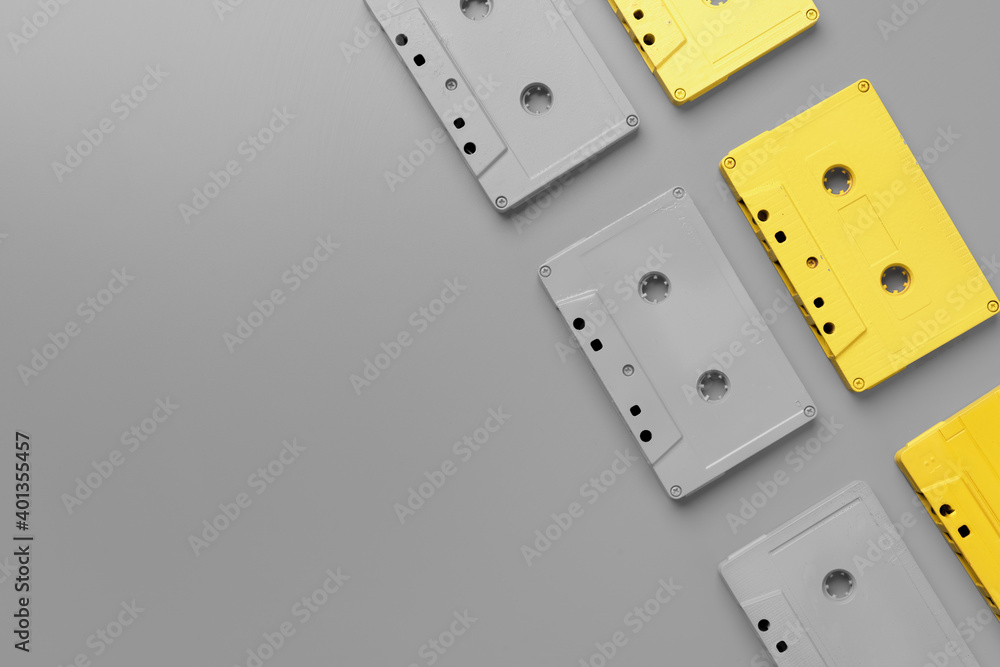 Yellow and gray audio cassettes on gray background top view Yellow and gray audio cassettes on gray background top view