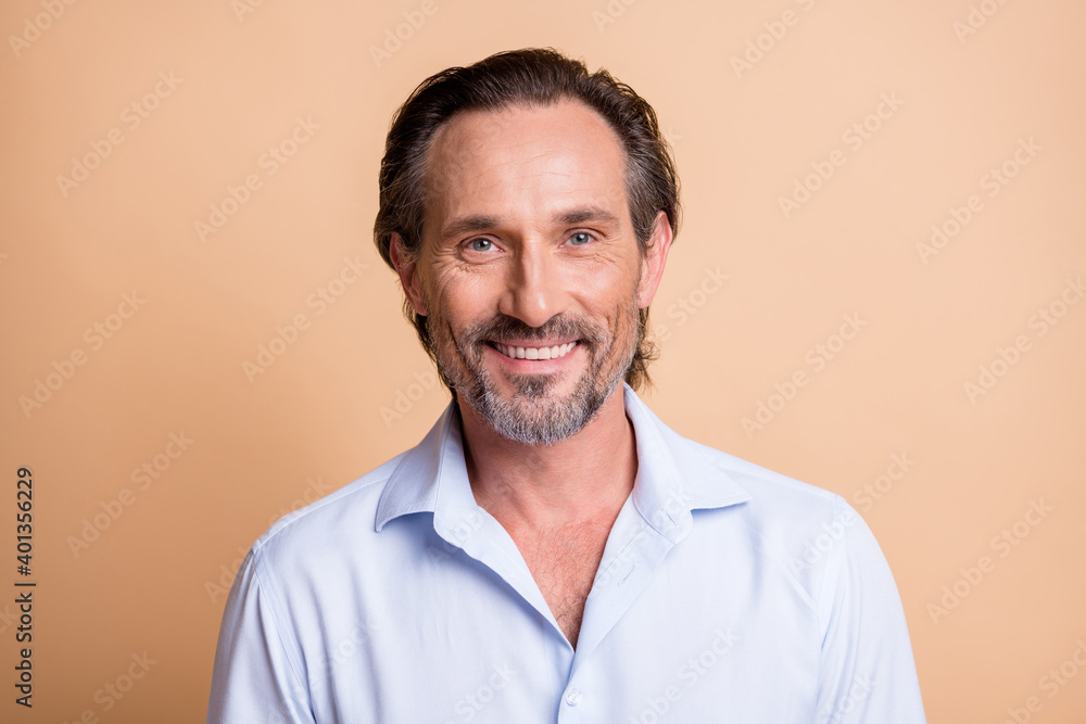 Photo of mature attractive bearded guy look camera beaming shiny smile wear white shirt isolated beige color background Photo of mature attractive bearded guy look camera beaming shiny smile wear white shirt isolated beige color background