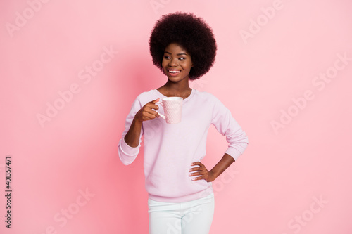 Portrait of charming cheery wavy-haired girl drinking enjoying fresh natural aromatic caffeine isolated on pink pastel color background