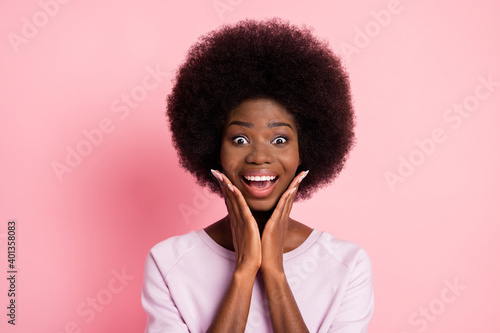 Portrait of lovely amazed cheerful delighted wavy-haired girl great news sale reaction isolated over pink color background