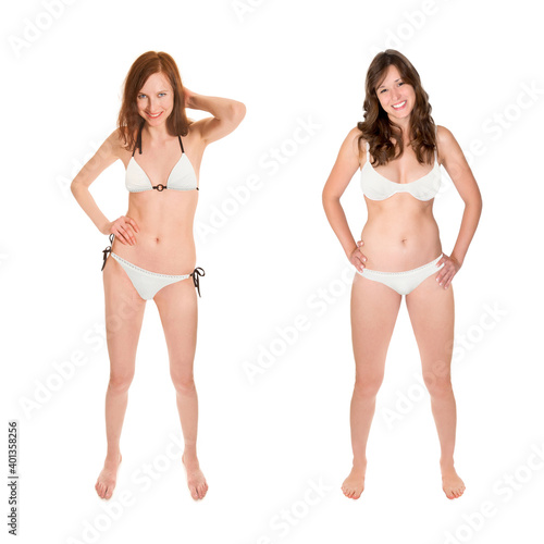 Two full length portraits of beautiful young women wearing white bikinis, isolated in front of white studio background