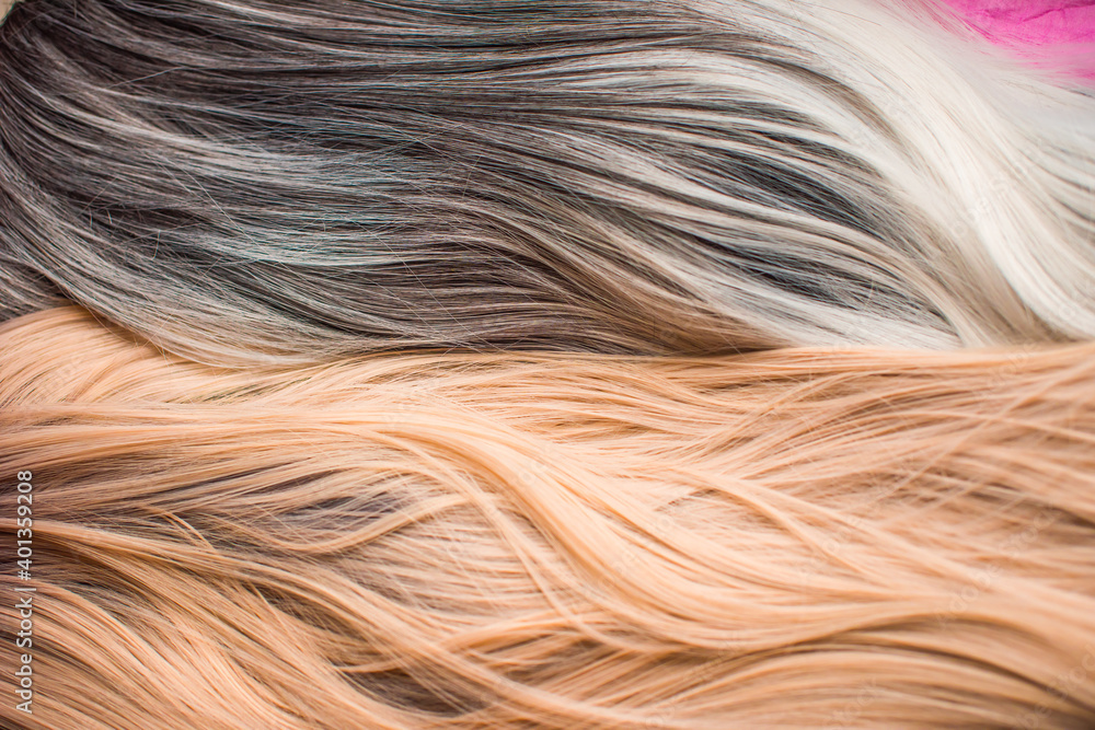 Naklejka premium Wigs, natural and synthetic hair. Women's beauty concept. Close up photo of wig, hair for ladies