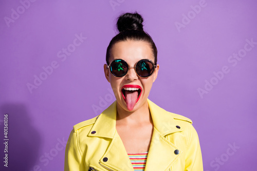 Photo of crazy youngster girl stick tongue red pomade isolated over violet color background © deagreez