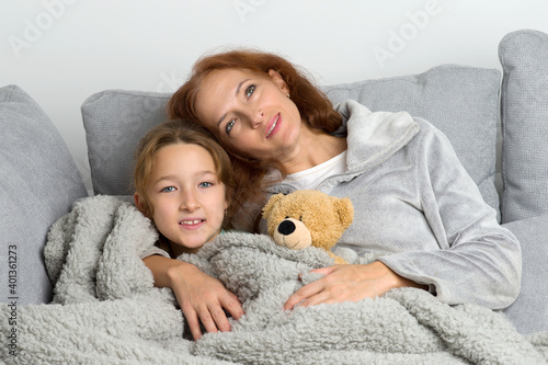 Mom sitting on couch with daughter