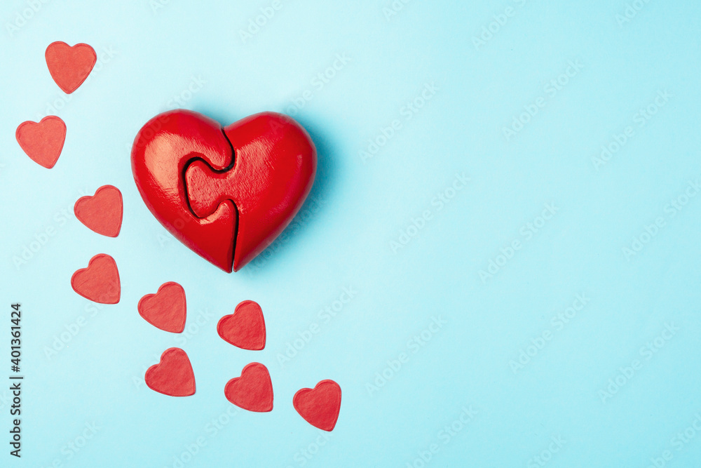 Red puzzle heart  on blue background.Medical psychology concept. Valentines day concept.
