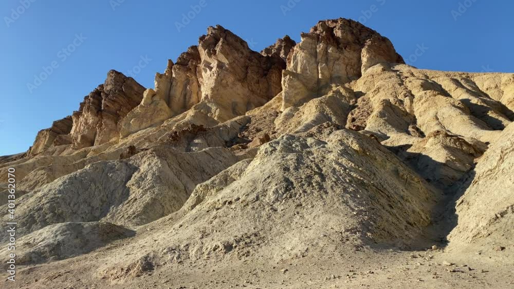 Beautiful rock formations at the Golden Canyon at sunset at Death Valley National Park, CA, USA. Slow pan to the left. Beautiful rock formations at the Golden Canyon at sunset at Death Valley National Park, CA, USA. Slow pan to the left.