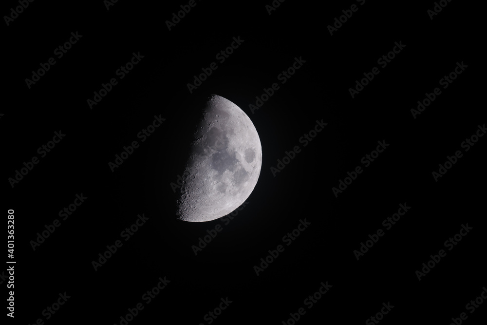 Half moon against a dark black sky Half moon against a dark black sky