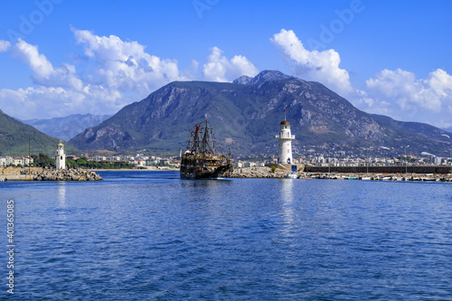 A large pirate ship enters the port between two lighthouses in Alanya (Turkey). Beautiful seascape of the bay in the resort town of the Turkish Riviera © ioanna_alexa