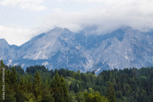 Beautiful Alpine mountainous scenery on the road to the city of Siena, Tuscany, Italy. Alps mountains on cloudy and foggy day. Soft selective focus, long exposure