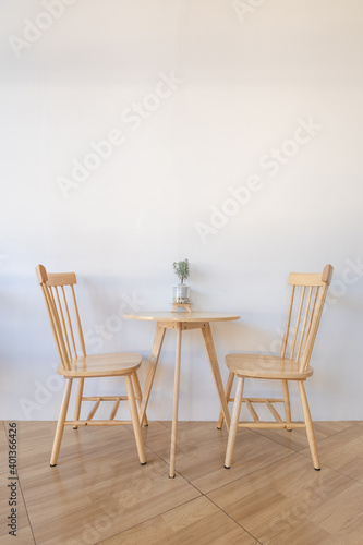 Modern set of wooden table and chairs interior in living room or coffee shop decoration with white wall concrete background